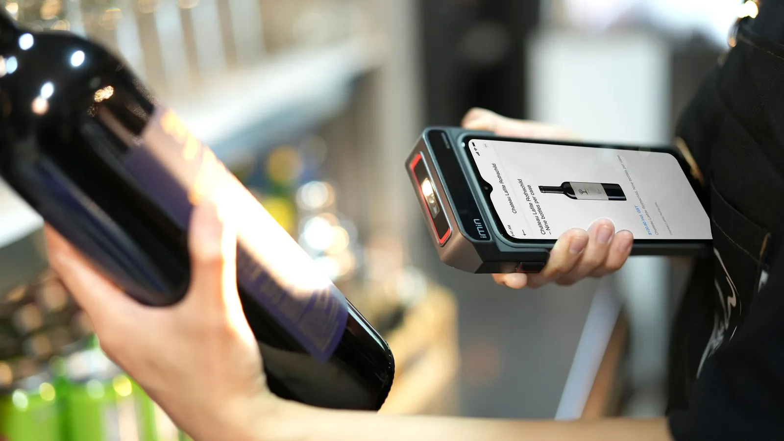 A shop worker scans a wine bottle with a handheld device whose screen shows the product's name, price, and units per case, standing in for the structured record an AI agent needs before it can buy.