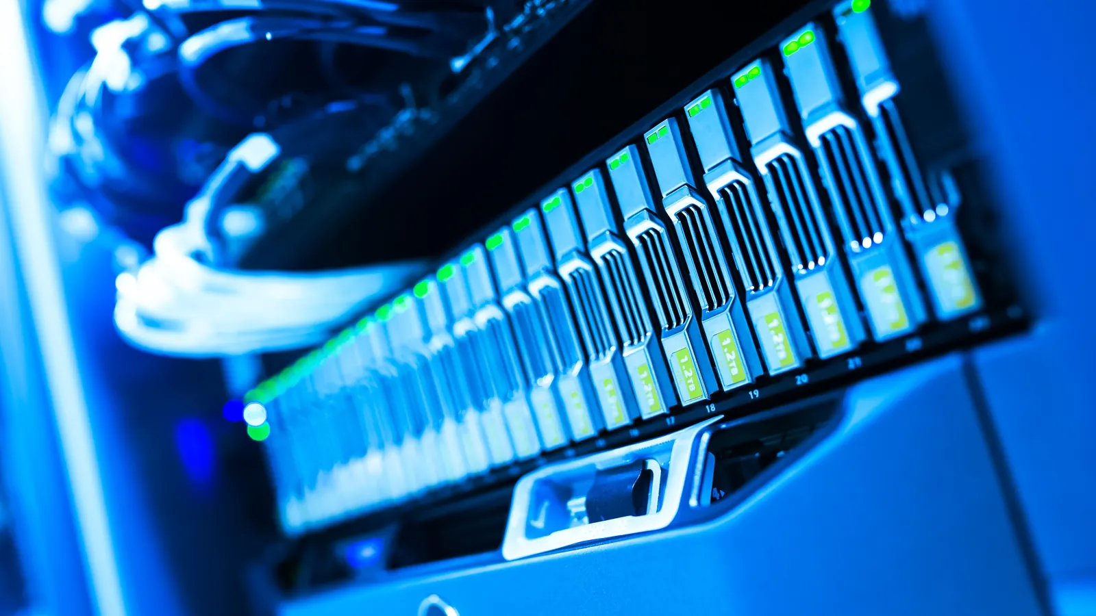 A blue-lit server rack in a data center, rows of drives glowing from behind, representing the trust and verification infrastructure now forming around AI shopping agents.