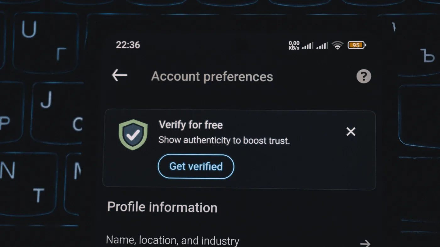A smartphone screen prompts a user to 'Get verified' to boost trust, illustrating the verification step now sitting between a shopper's request and a merchant getting recommended.