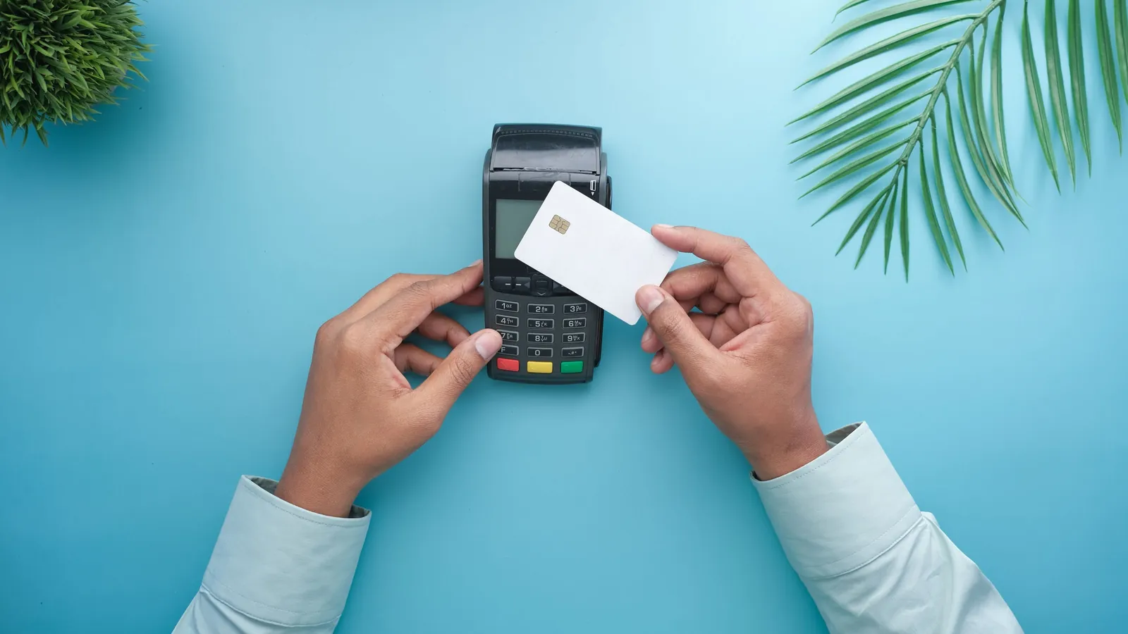 A hand making a contactless card payment on a small terminal, standing in for AI agents that can now complete a purchase from start to finish.